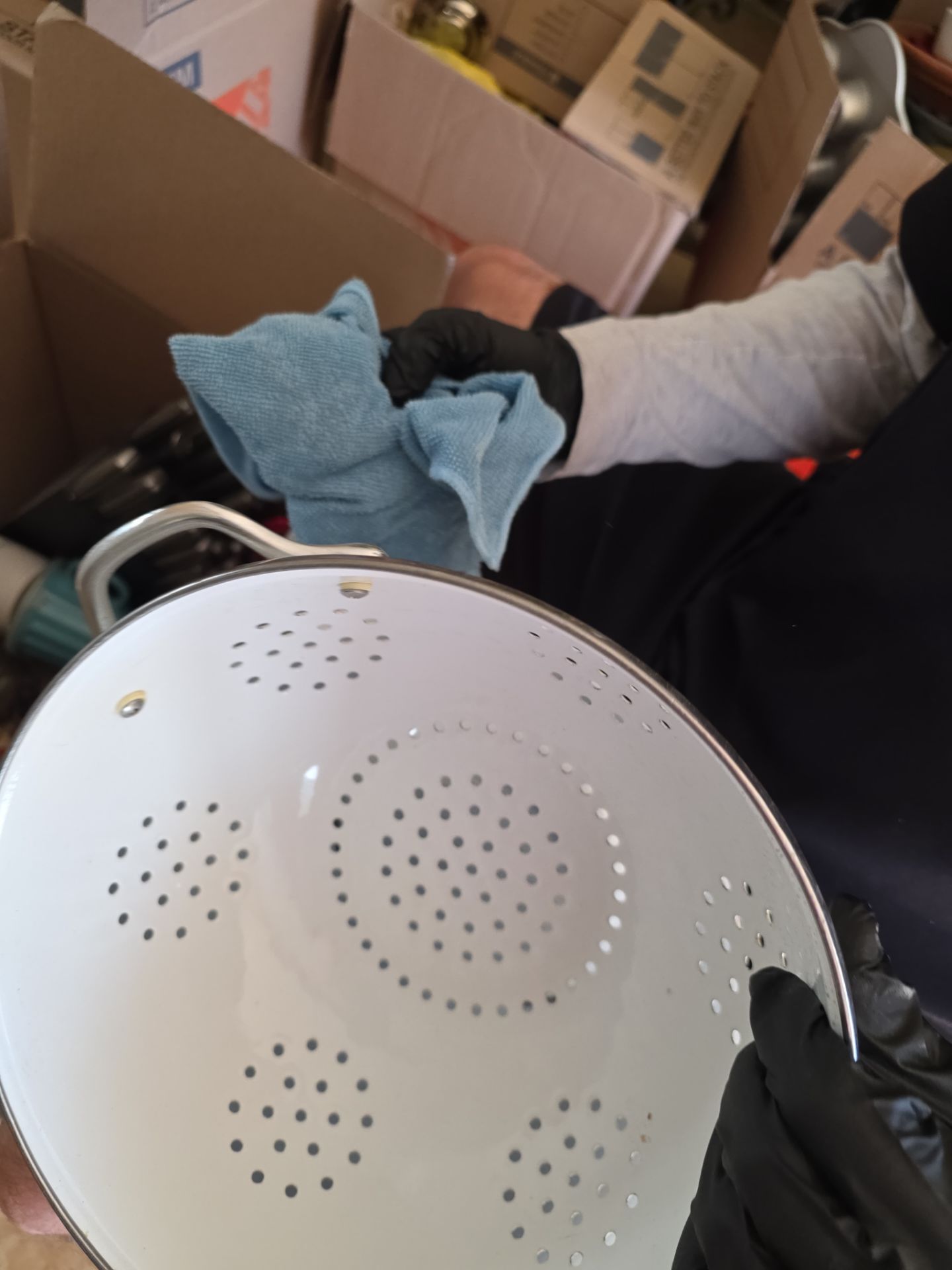 Technician cleaning smoke-damaged cookware and household items